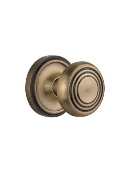 Classic Rosette Door Set with Streamline Deco Knobs in Antique Brass.